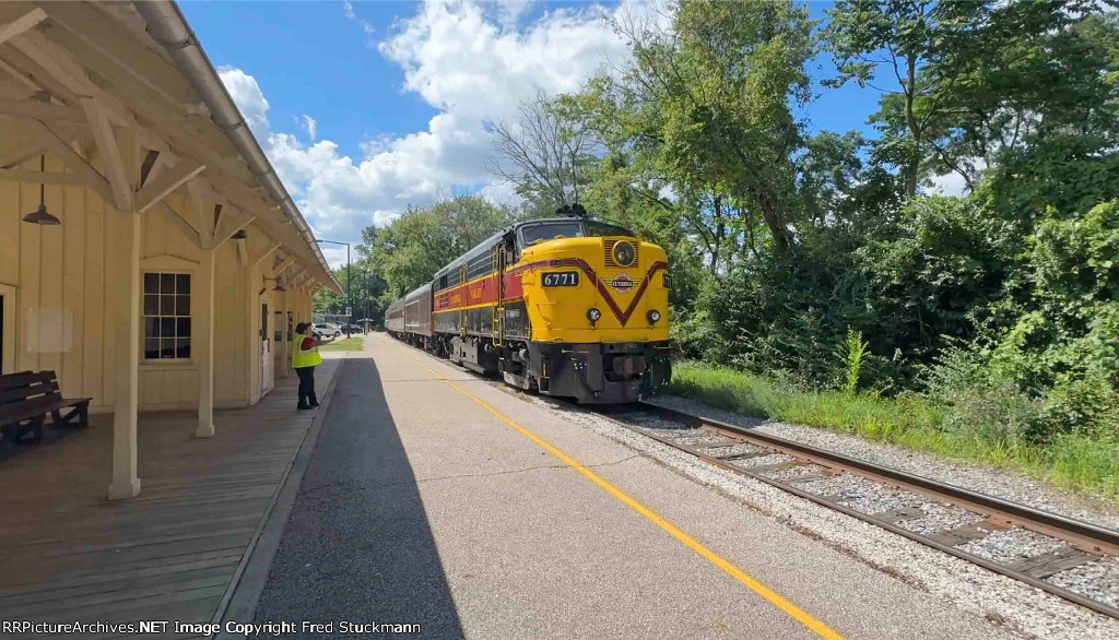 CVSR 6771 leaves the station agent and the empty station behind.